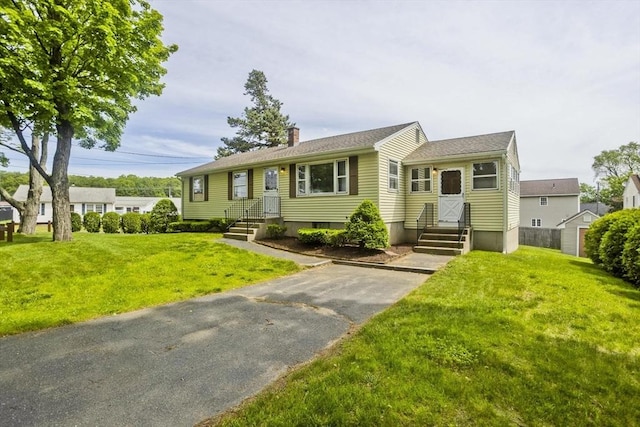 51 Hardy St, Springfield, MA 01129 - view of front facade with a chimney and a front lawn