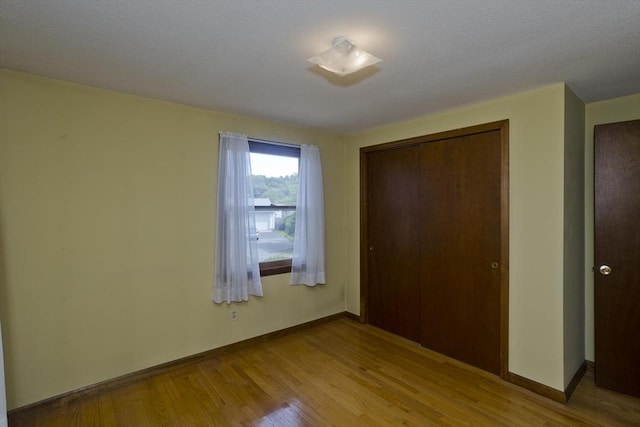 51 Hardy St, Springfield, MA 01129 - unfurnished bedroom featuring light wood-style flooring, a closet, and baseboards