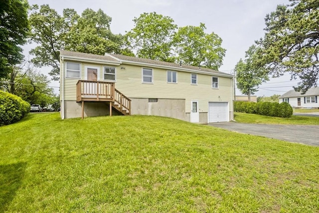 51 Hardy St, Springfield, MA 01129 - rear view of house with asphalt driveway, a garage, and a lawn