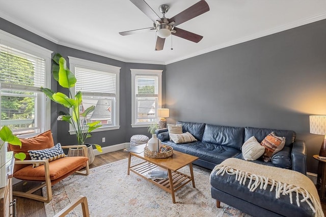 living room with wood finished floors, crown molding, ceiling fan, and baseboards
