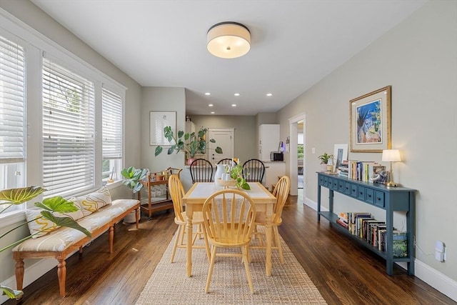 dining space with wood-type flooring, baseboards, and recessed lighting