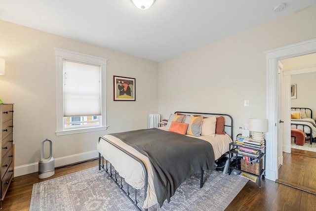 bedroom featuring wood finished floors and baseboards