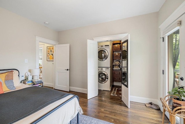 bedroom with stacked washing machine and dryer, dark wood-style flooring, and baseboards