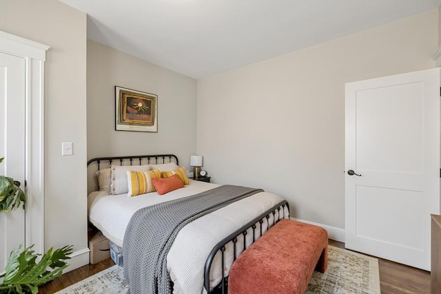 bedroom featuring wood finished floors and baseboards