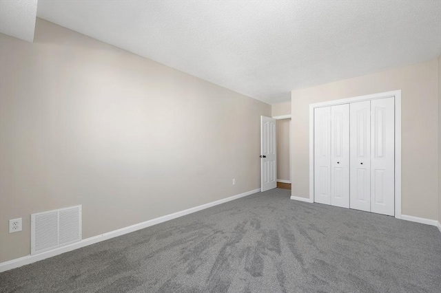 unfurnished bedroom with baseboards, visible vents, a closet, and carpet flooring