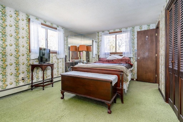 carpeted bedroom featuring a textured ceiling and baseboard heating