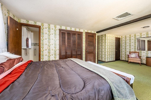 bedroom featuring carpet flooring and a textured ceiling