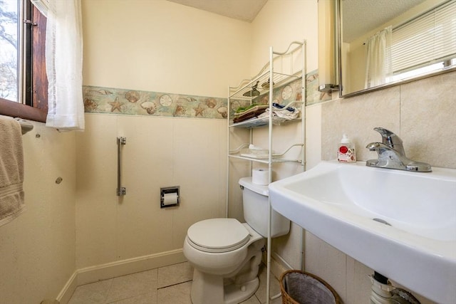 bathroom featuring tile patterned flooring, sink, and toilet