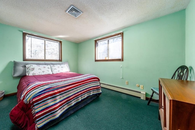 bedroom with a baseboard radiator and a textured ceiling