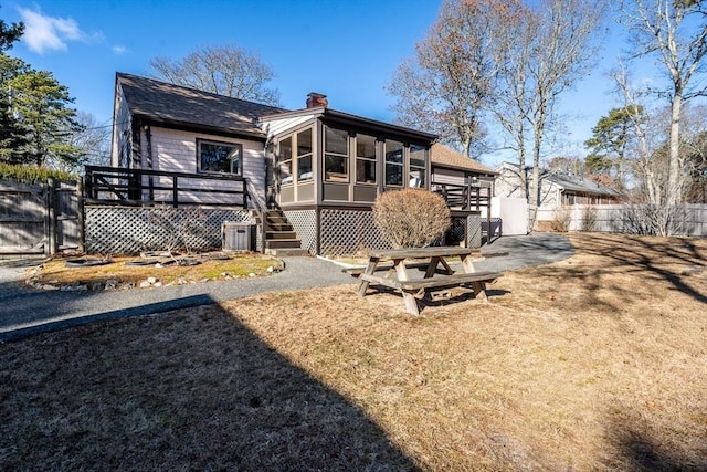 back of house featuring a sunroom