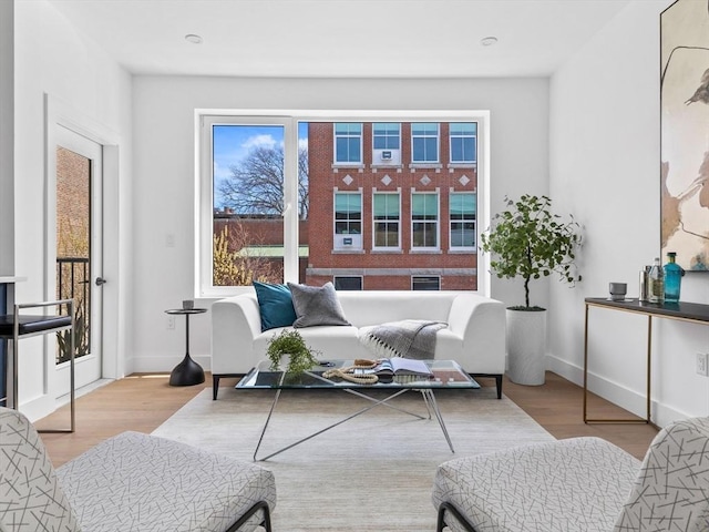 living area featuring baseboards and wood finished floors
