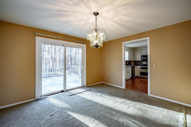 empty room with an inviting chandelier, baseboards, dark colored carpet, and a textured ceiling