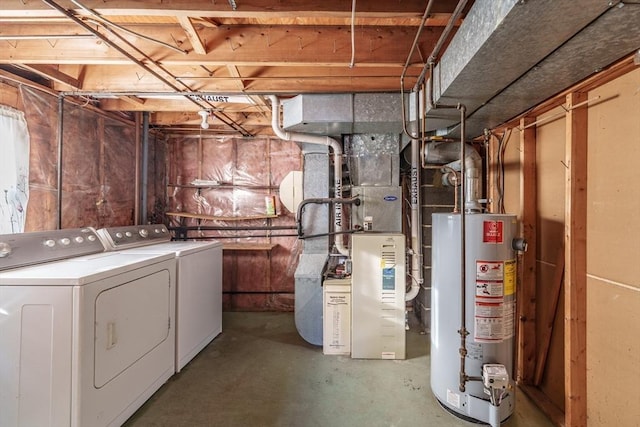 unfinished below grade area featuring water heater, heating unit, and washer and clothes dryer