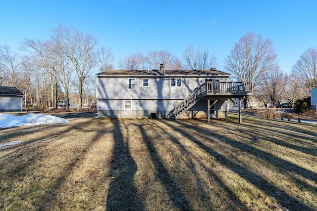 rear view of house with a yard, a chimney, stairs, and a deck