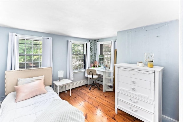 16 Summer St, Easton, MA 02356 - bedroom with baseboard heating, multiple windows, light wood-style flooring, and a desk
