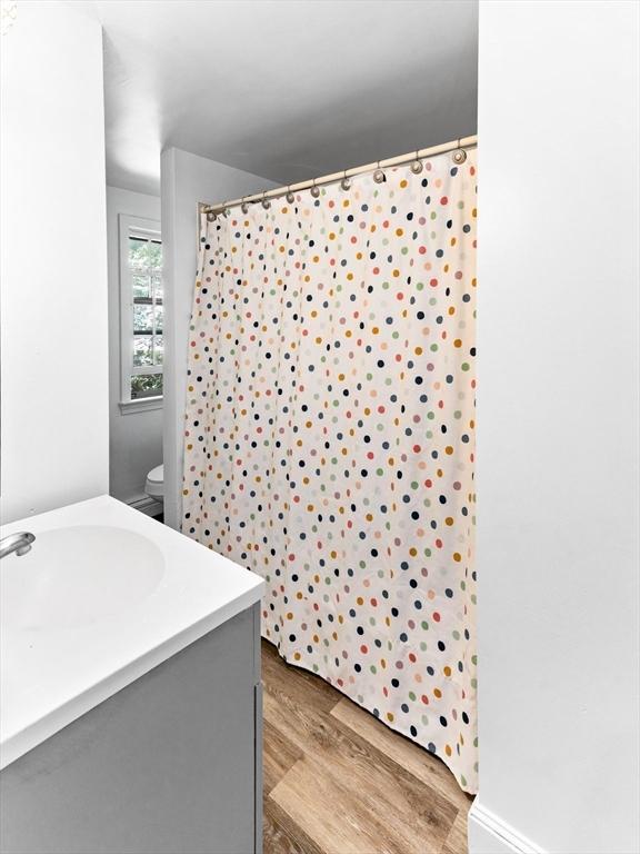 16 Summer St, Easton, MA 02356 - bathroom with vanity, wood finished floors, a shower with curtain, and toilet