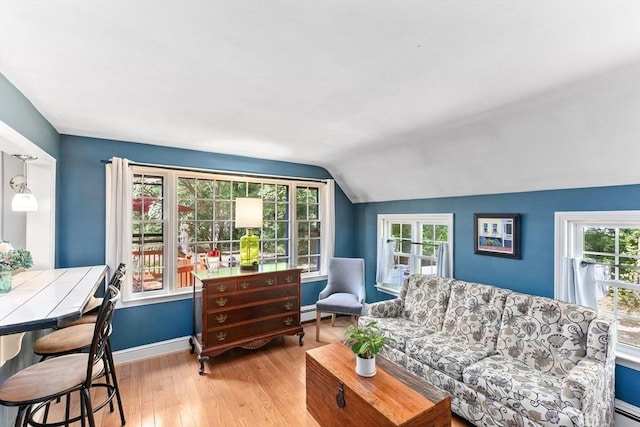 16 Summer St, Easton, MA 02356 - living room with vaulted ceiling, wood finished floors, baseboards, and a baseboard radiator