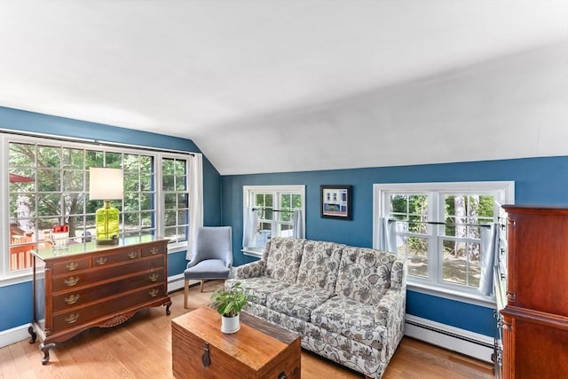16 Summer St, Easton, MA 02356 - living area with a baseboard radiator, lofted ceiling, healthy amount of natural light, wood finished floors, and baseboards