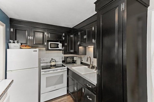 16 Summer St, Easton, MA 02356 - kitchen featuring white appliances, a sink, dark cabinets, light countertops, and light wood-style floors