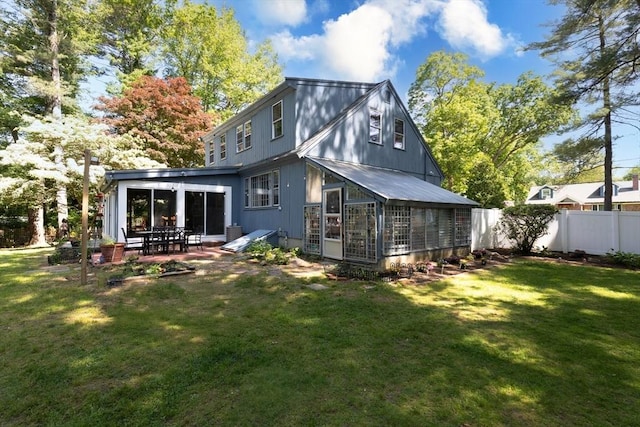 16 Summer St, Easton, MA 02356 - rear view of house with a patio area, a sunroom, and metal roof