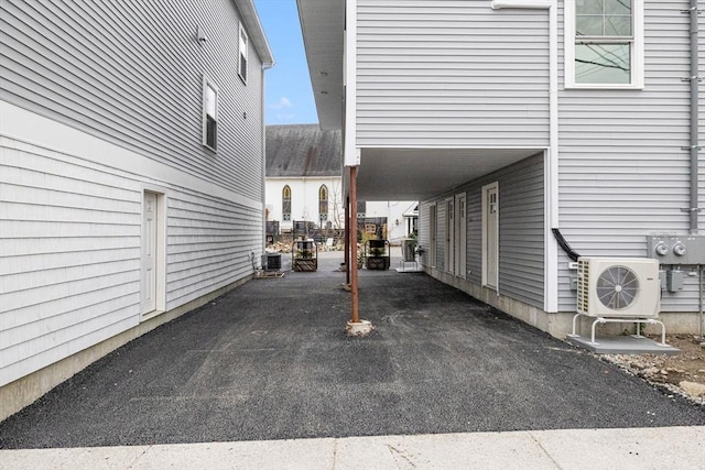 view of vehicle parking with a carport and ac unit