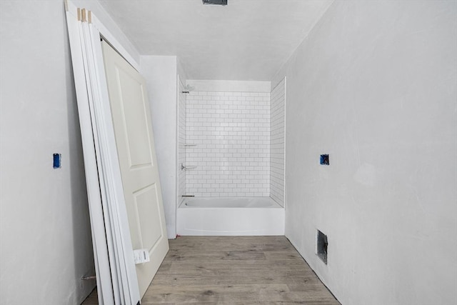bathroom featuring hardwood / wood-style floors and tiled shower / bath