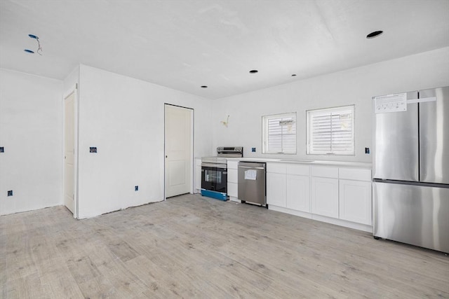 kitchen featuring white cabinetry, appliances with stainless steel finishes, and light wood-type flooring