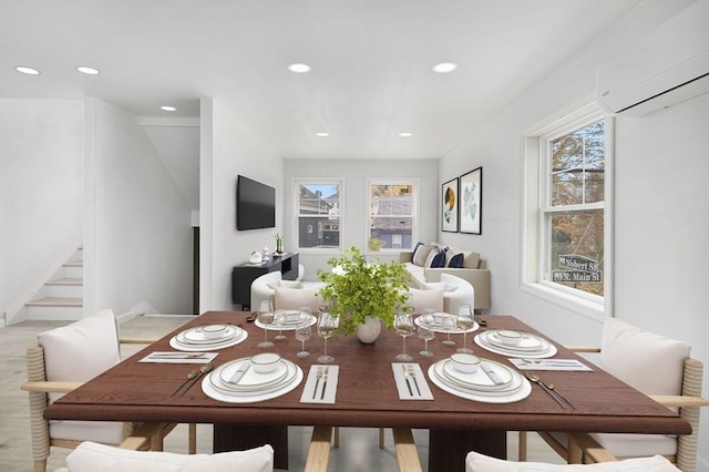 dining space with a wall mounted AC