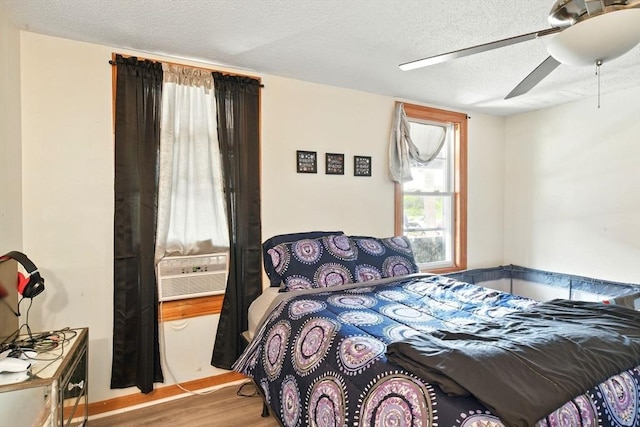 47 N Summer St, Holyoke, MA 01040 - bedroom featuring wood finished floors, a textured ceiling, a ceiling fan, and cooling unit