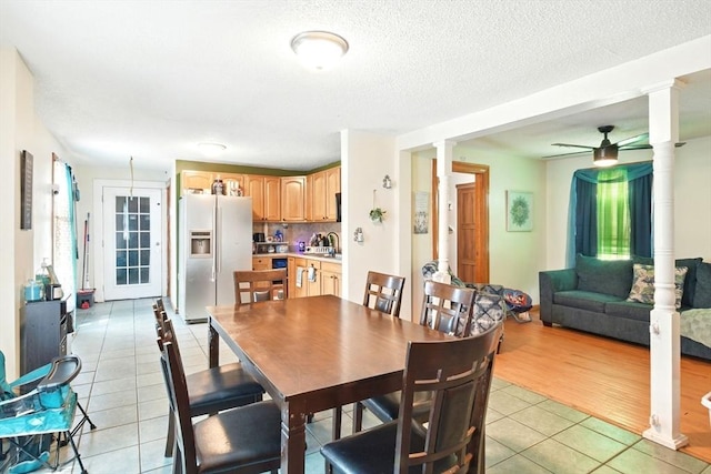 47 N Summer St, Holyoke, MA 01040 - dining area featuring light tile patterned flooring, ornate columns, a ceiling fan, and a textured ceiling