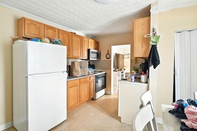 47 N Summer St, Holyoke, MA 01040 - kitchen featuring freestanding refrigerator, stainless steel microwave, electric stove, light countertops, and an ornate ceiling