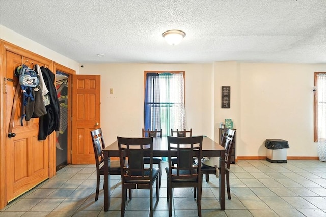 47 N Summer St, Holyoke, MA 01040 - dining space with a textured ceiling, light tile patterned floors, and baseboards