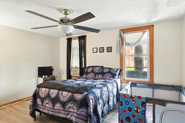 47 N Summer St, Holyoke, MA 01040 - bedroom featuring wood finished floors, a textured ceiling, ceiling fan, and baseboards
