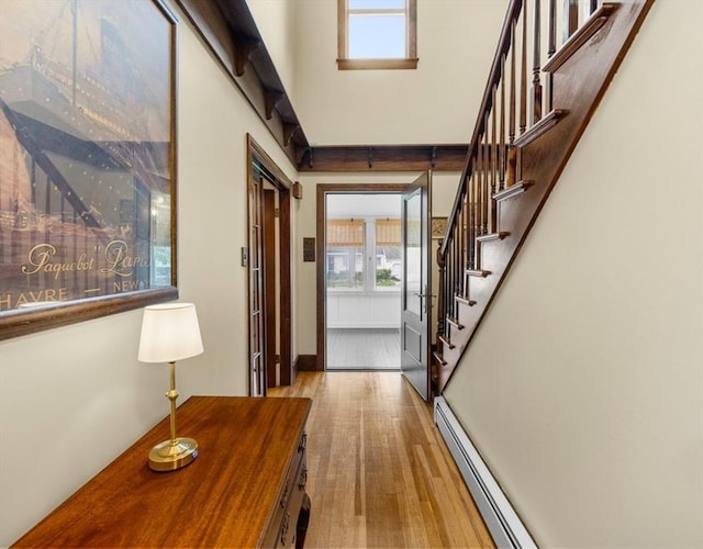 71 Dudley St, Marlborough, MA 01752 - entrance foyer with wood finished floors, stairway, and a baseboard radiator