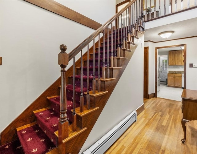 71 Dudley St, Marlborough, MA 01752 - stairway with a baseboard heating unit, wood finished floors, and baseboards