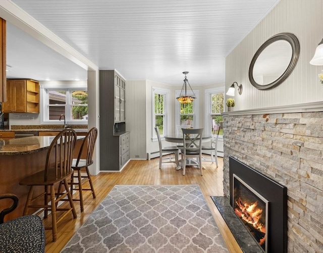 71 Dudley St, Marlborough, MA 01752 - dining space with light wood-style flooring and a stone fireplace