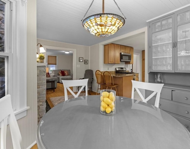 71 Dudley St, Marlborough, MA 01752 - dining area with wood finished floors, a chandelier, and a fireplace