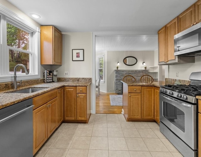 71 Dudley St, Marlborough, MA 01752 - kitchen featuring appliances with stainless steel finishes, a sink, stone countertops, and brown cabinetry