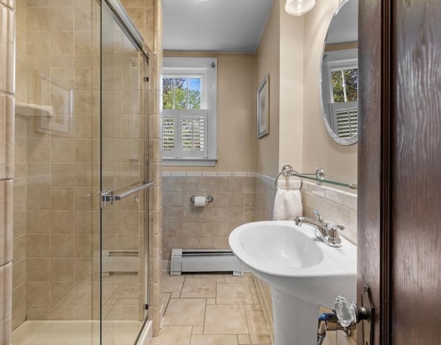 71 Dudley St, Marlborough, MA 01752 - bathroom featuring a baseboard radiator, tile walls, a shower stall, and wainscoting