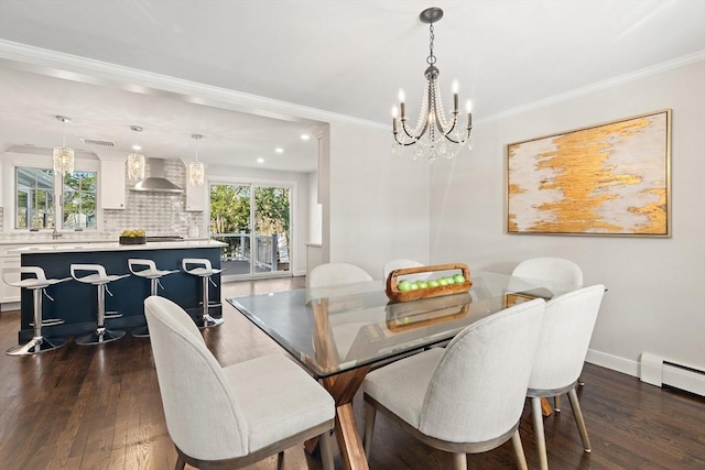 dining area featuring a baseboard radiator, ornamental molding, a notable chandelier, and dark wood-type flooring