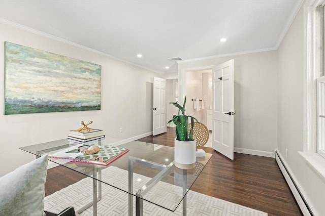 dining room with dark hardwood / wood-style flooring, a baseboard heating unit, and crown molding