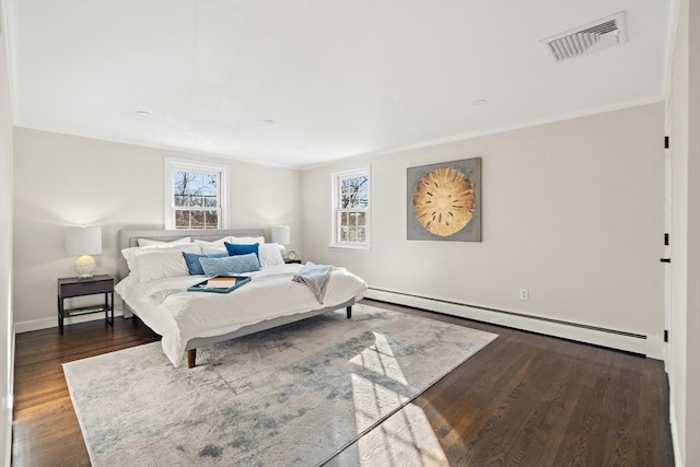 bedroom with baseboard heating, crown molding, and dark hardwood / wood-style flooring