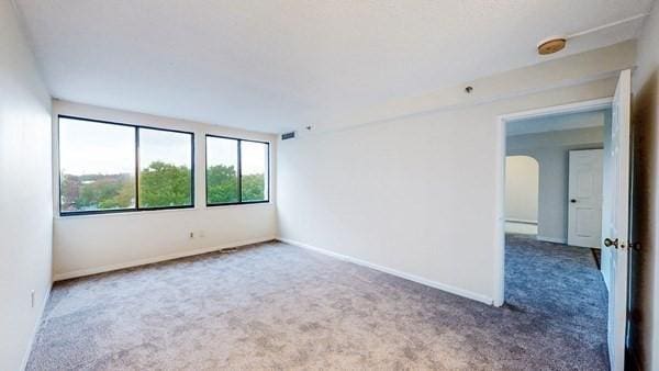 250 Hammond Pond Pkwy Unit 707S, Newton, MA 02467 - unfurnished room with carpet floors, baseboards, arched walkways, and a smoke detector