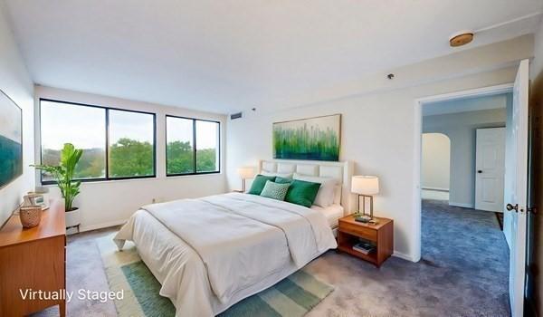 250 Hammond Pond Pkwy Unit 707S, Newton, MA 02467 - bedroom featuring carpet flooring, arched walkways, and baseboards