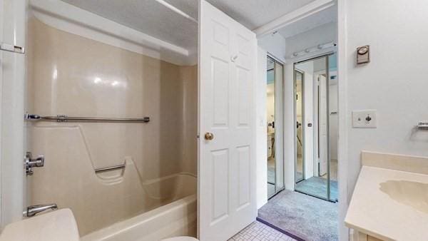 250 Hammond Pond Pkwy Unit 707S, Newton, MA 02467 - full bathroom featuring vanity, toilet, and washtub / shower combination
