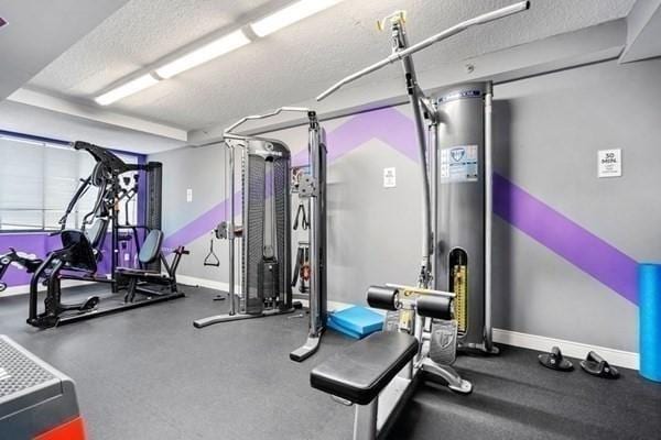 250 Hammond Pond Pkwy Unit 707S, Newton, MA 02467 - workout area with a textured ceiling and baseboards