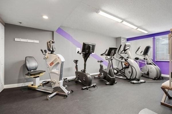250 Hammond Pond Pkwy Unit 707S, Newton, MA 02467 - exercise room with a textured ceiling and baseboards