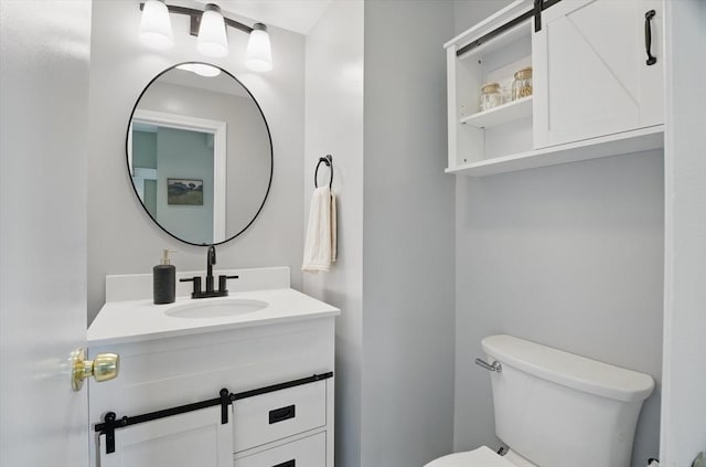 bathroom with toilet and vanity