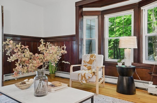 dining area featuring a wainscoted wall and wood finished floors