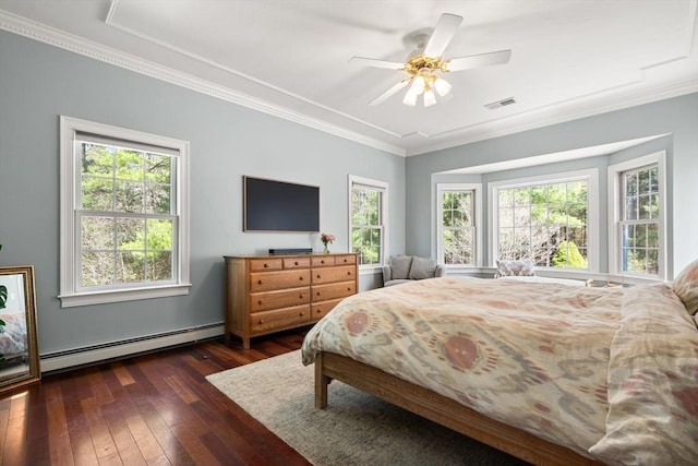 bedroom featuring crown molding, a baseboard heating unit, dark wood-type flooring, and visible vents